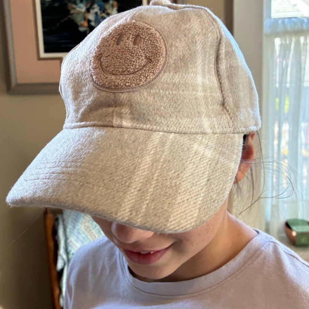 Steve Madden plaid smiley face ball hat